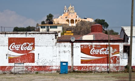 The church of Nuestra Senora de los Remedios in Cholula, Mexico, and signs for Coca Cola