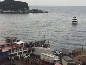 Residents leave Goma by boat on Lake Kivu