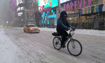 A man cycles through the snow in Times Square in New York last month.