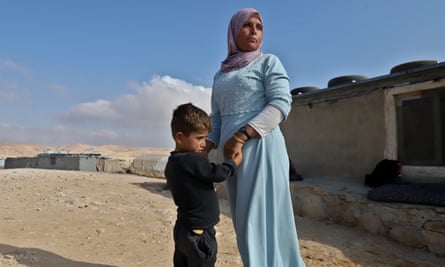 Mina Abu Aram, 35 holds her son Ammar Talib Abu Aram