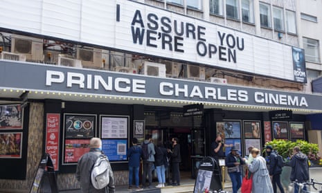 People queue outside the Prince Charles cinema in central London as it reopens on 17 May