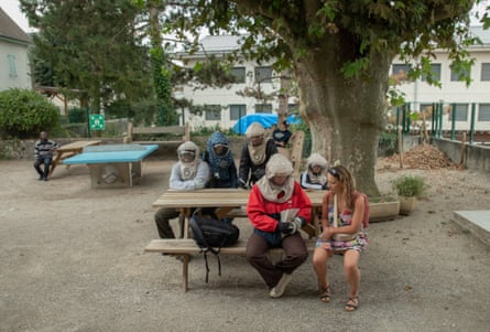 Children of the Moon sitting at a picnic table wearing helmets