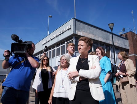 Manchester mayor Bev Craig speaks outside during a walkabout, surrounded by onlookers and a camera crew
