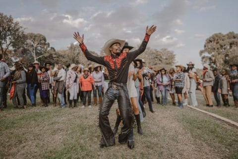 Sheriff Knight (centre), the ‘Dancing Cowboy,’ leads the line dance during International Cowboy Day.