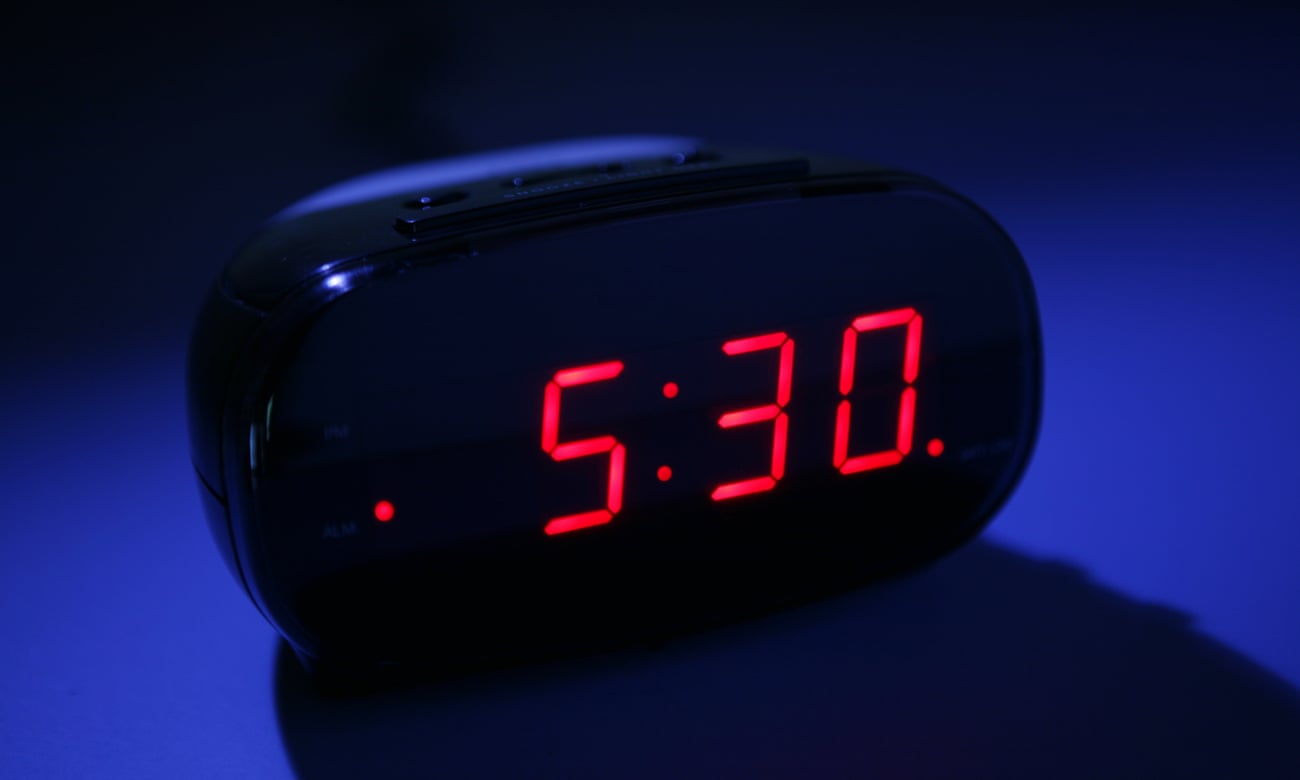 An alarm clock in dark saying 5.30