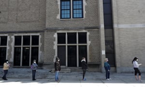 Voters observe social distancing guidelines as they wait in line to cast ballots in the Wisconsin primary.