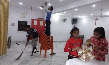 Children are busy cleaning and decorating a church for the Christmas in a small Christian locality in Aligarh.