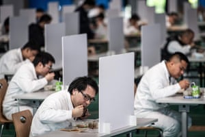 Employees eat lunch at the Dongfeng Honda factory in Wuhan