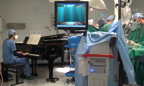 Roberto Trignani removes a double tumour in the spine of a 10-year-old as molecular biologist Emiliano Toso plays the piano.
