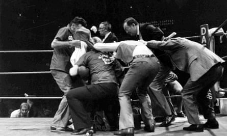 The aftermath of the title bout between Alan Minter and Marvin Hagler, halted by the referee in the third round, as beer bottles are thrown into the ring by spectators at Wembley, September 1980.