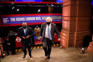British Prime Minister Boris Johnson arrives on an electric bus with other leaders