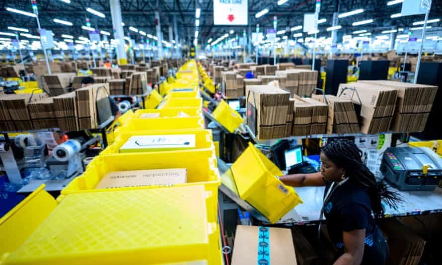 Aa woman works at a packing station at an Amazon fulfillment center in Staten Island, New York. A similar facility in Bessemer, Alabama, could be the first to unionize depending on a vote scheduled for 8 February.
