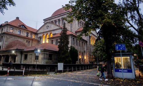 A police officer stands in a police facility, right, outside a synagogue in Frankfurt, Germany, early on Thursday.