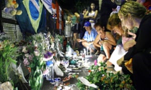 Relatives and friend s of victims light candles after the blaze at the Buenos Aires music venue.
