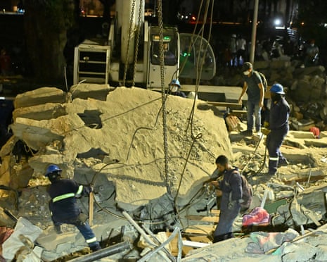 Rubble is moved amid the search at Plaza Bolivar