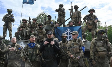 Group of soldiers with the russian volunteer corps flag