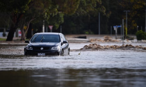 A car is seen submerged in flood water in Traralgon, Victoria