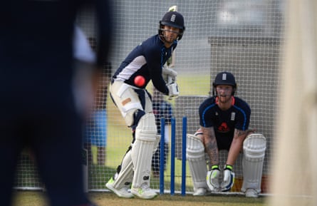 The England batsman Dawid Malan focuses on the ball as Ben Stokes looks on during a nets session.