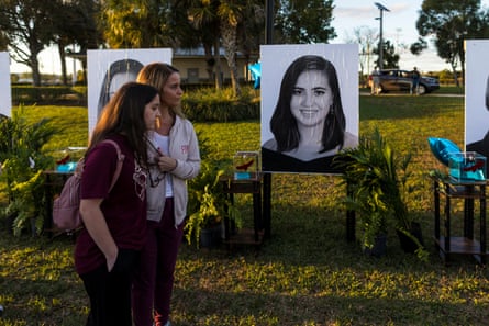 People visit a memorial on the 5th anniversary of the Marjory Stoneman Douglas high school mass shooting in February 2023.