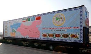 A train container covered with a tarpaulin depicting the ancient Silk Road.