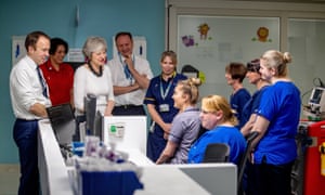 The health secretary, Matt Hancock (left), joins Theresa May and the chief executive of NHS England, Simon Stevens (centre), during a trip to Alder Hey children’s hospital in Liverpool, UK