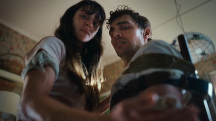 A man tied to a chair and a woman look frightened in scene from the film.