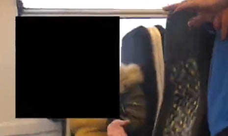 Screen grab of footage of a passenger on a Merseyrail train who challenged Karolina Pakenaite, who is deafblind, and her sister, Saule, 16, over the latter lifting her face covering.