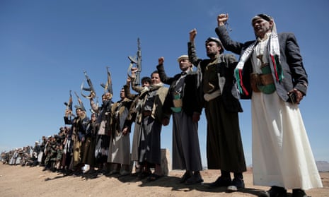 Yemen’s Houthi followers lift their rifles and shout slogans as they attend a tribal rally and parade held against the United States-led aerial attacks launched on sites in Yemen, and solidarity with Palestinians, on January 22, 2024, near Sana’a, Yemen.