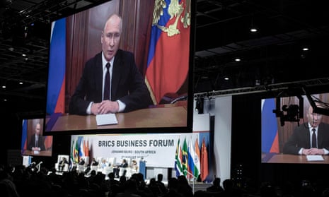 Putin addressing forum on a large video screen
