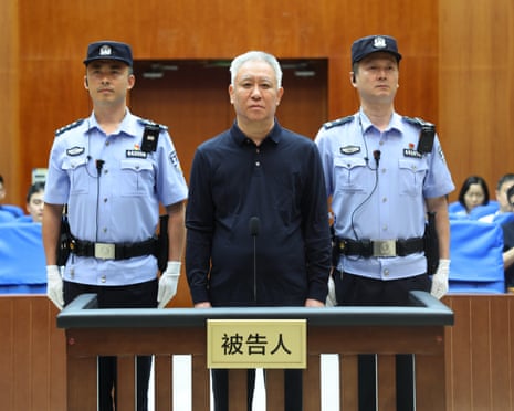 Hui Ka Yan in court flanked by uniformed law enforcement officers