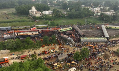 Rescuers amid tangled train carriages
