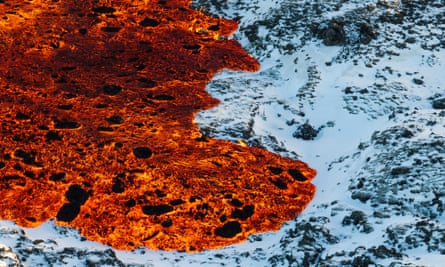 Lava flows down snow-covered paths