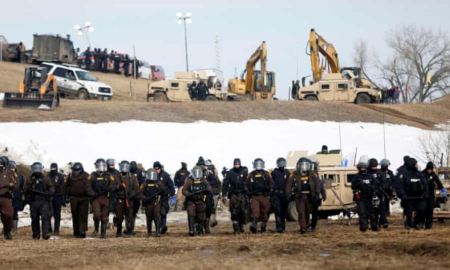 Conflict over the pipeline has been ongoing for years. Here, law enforcement officers advance into the main opposition camp against the Dakota Access oil pipeline near Cannon Ball, North Dakota, in 2017.