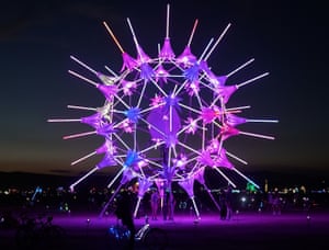 Looking like a magnified piece of pollen, this Burning Man artwork casts a purple glow onto the desert floor