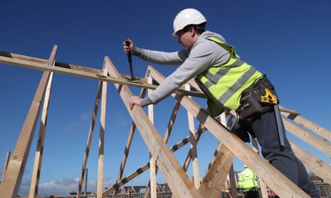 A Taylor Wimpey worker builds a roof on an estate in Aylesbury