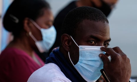 People wearing masks wait at the St. John’s Mobile Clinic to provide black workers with free Covid-19 testing in Los Angeles.