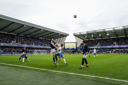 The players vie for an aerial ball.