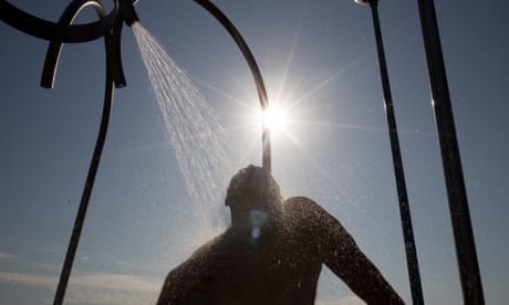 A man showers at Coogee beach