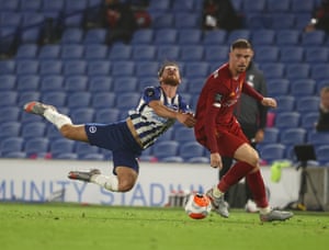Alexis Mac Allister of Brighton is shouldered off the ball by Jordan Henderson.