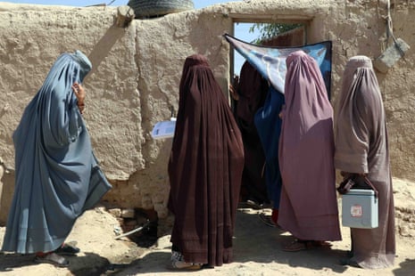 Afghan health workers administer polio vaccinations