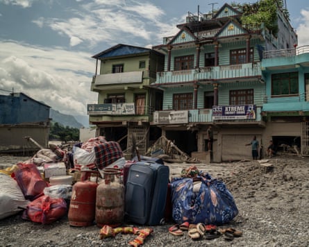 Pile of bags and fuel cylinders outside a house