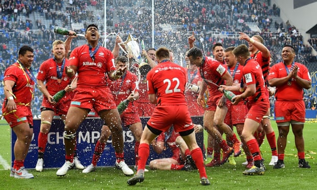 Saracens players celebrate with the trophy after beating Leinster 20-10 in the Champions Cup final.