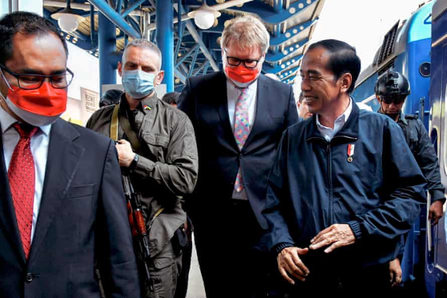 Handout picture from Indonesia’s Presidential Palace shows Indonesian President Joko Widodo (front R) walking with aides and escorting military personnel upon his arrival in Kyiv.