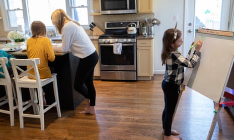 Farrah Eaton assists her daughters with home schooling on 18 March in New Rochelle, New York. 