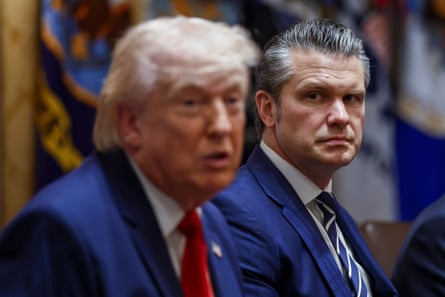 A man looks at the man who is sitting next to him and speaking