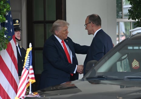 US President Donald Trump (L) greets Friedrich Merz, the newly inaugurated German chancellor, before their meeting at the White House.