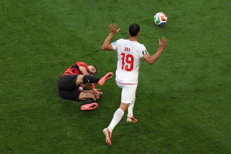 Ali Nemati gets a yellow for a cynical tug on Mo Salah.