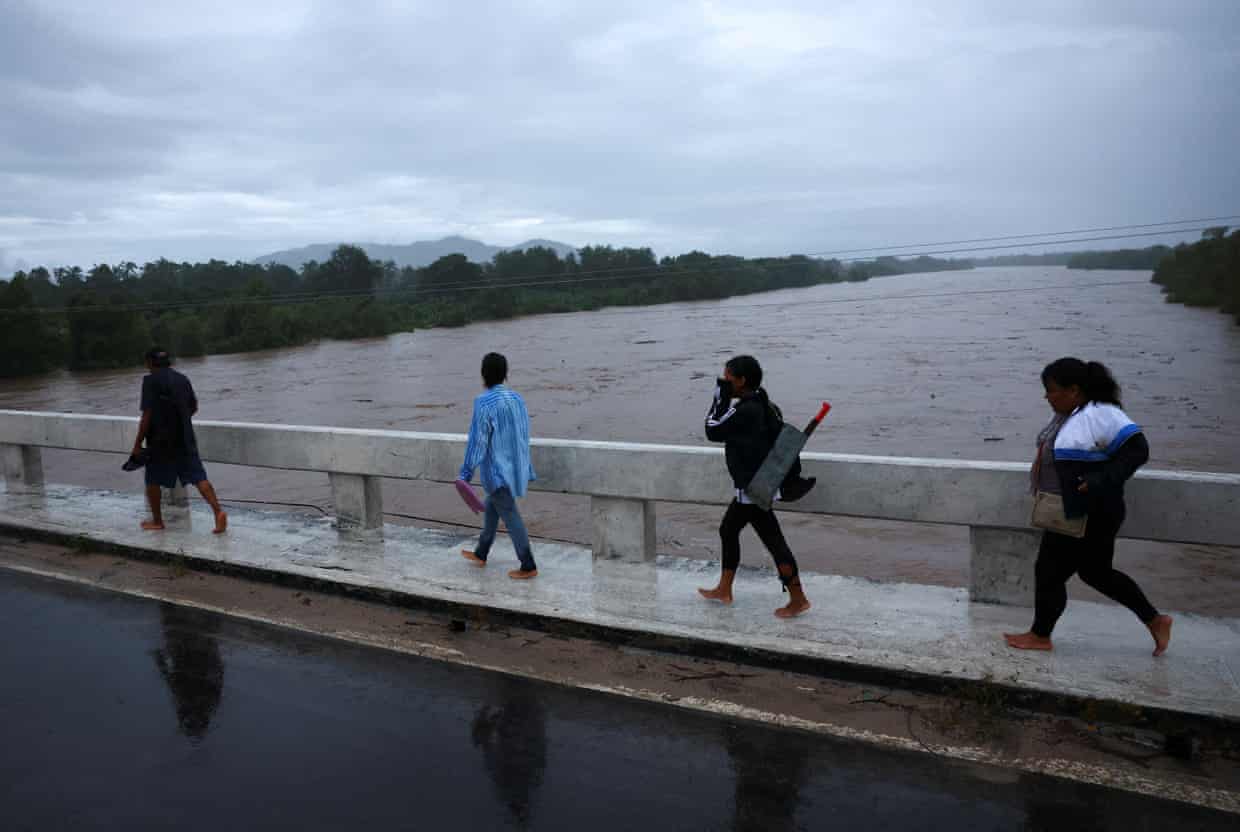 İnsanlar, Kasırga Simonun Meksikanın Sakit Okean sahilinə yaxınlaşdığı Jalisco ştatının Costalegre şəhərində selə dönmüş çayın üzərindəki körpüdən keçir. Fotoqraf: Daniel Becerril/Reuters