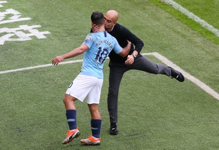 August 19: Manchester City’s manager Pep Guardiola congratulates Sergio Aguero with a kiss on the cheek during their match against Huddersfield Town.