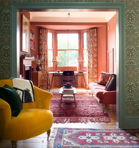 The sitting room, formerly separated by a wall, where William Morris wallpaper gives way to the warm but serene tones of the study.